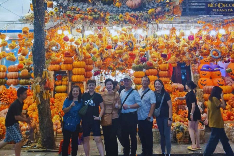 Group of travelers enjoying pumpkin street decor in Hanoi with Auasia Travel